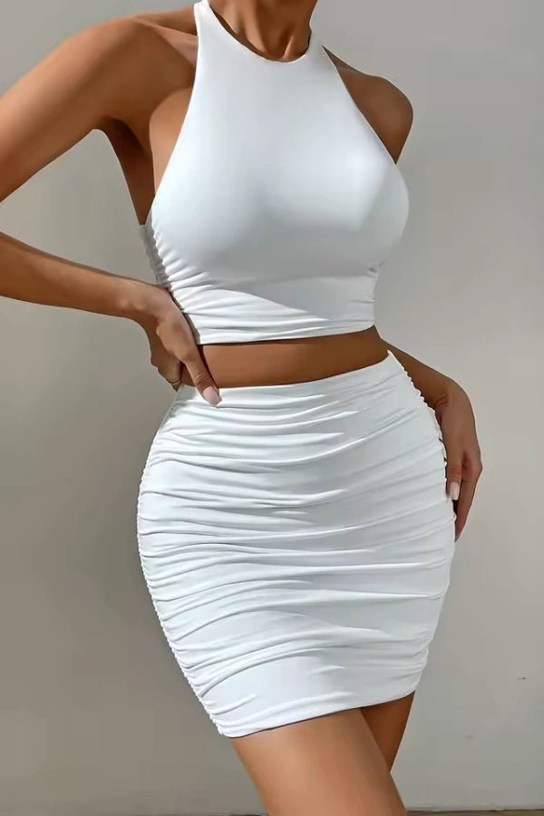 Bodycon set featuring a high-neck crop top and a ruched mini skirt, ideal for a chic evening out. 1