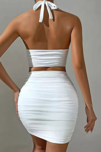 Bodycon set featuring a high-neck crop top and a ruched mini skirt, ideal for a chic evening out. 5