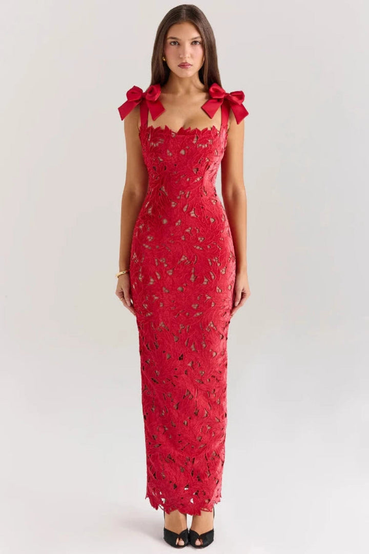 Elegant column gown featuring intricate lace detailing and statement bows, perfect for formal occasions. 0