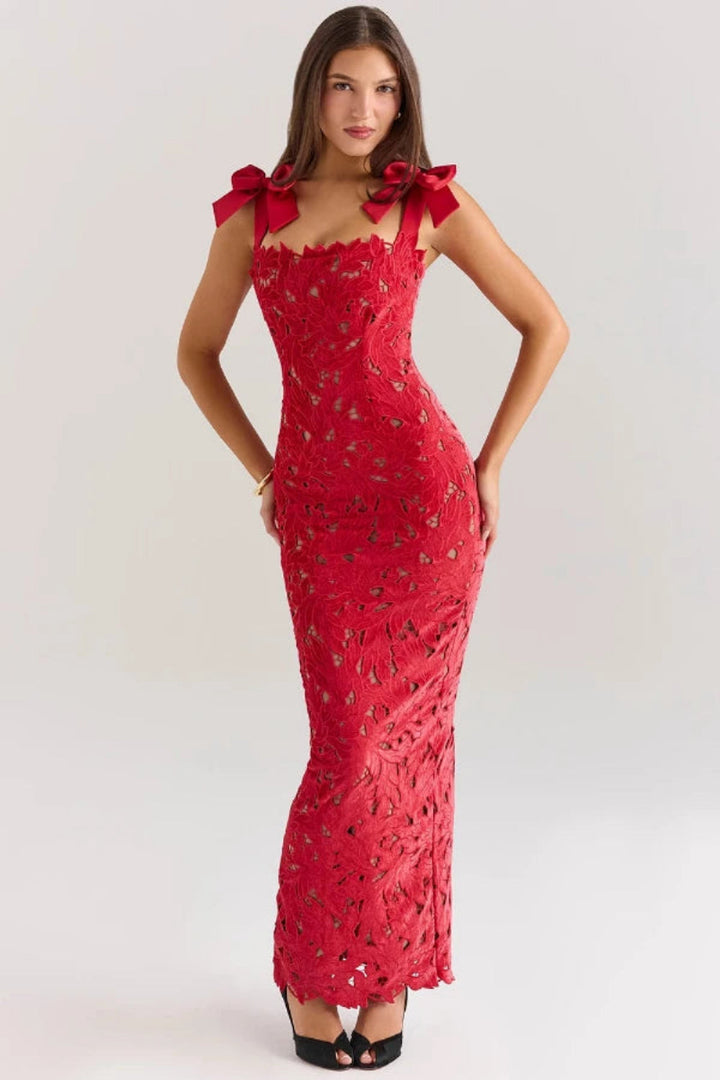 Elegant column gown featuring intricate lace detailing and statement bows, perfect for formal occasions. 1