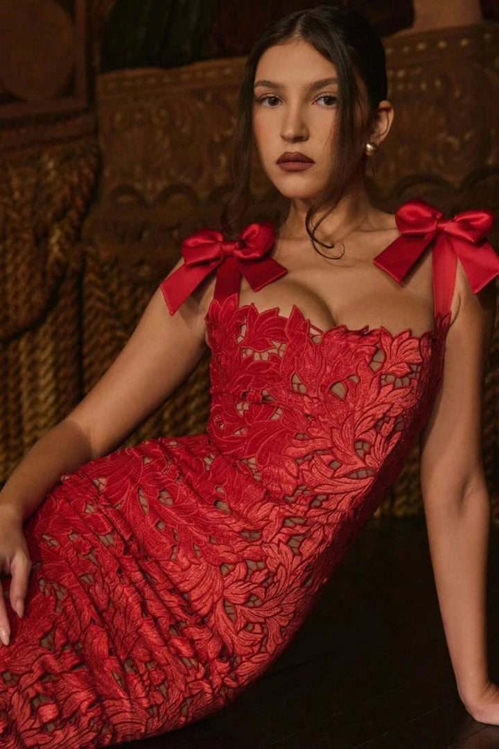 Elegant column gown featuring intricate lace detailing and statement bows, perfect for formal occasions. 3