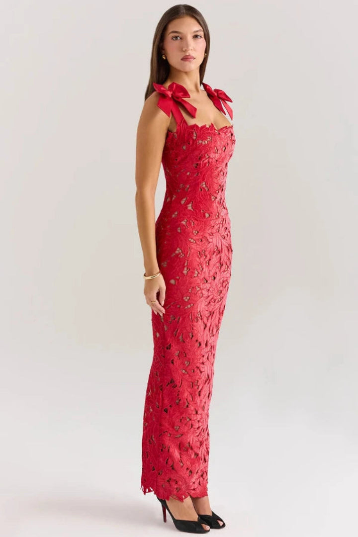 Elegant column gown featuring intricate lace detailing and statement bows, perfect for formal occasions. 4