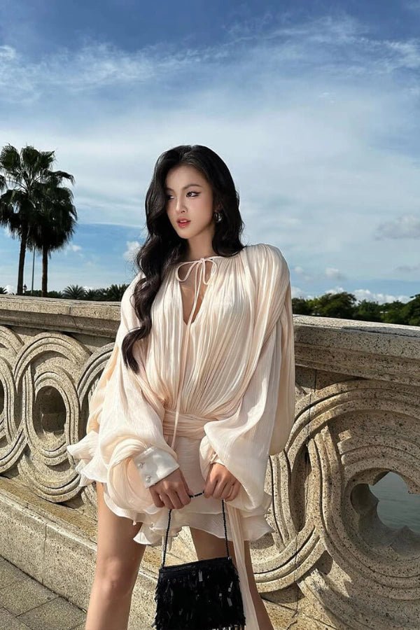 Elegant midi dress with sculpted sleeves and a cinched waist, perfect for formal occasions. 3