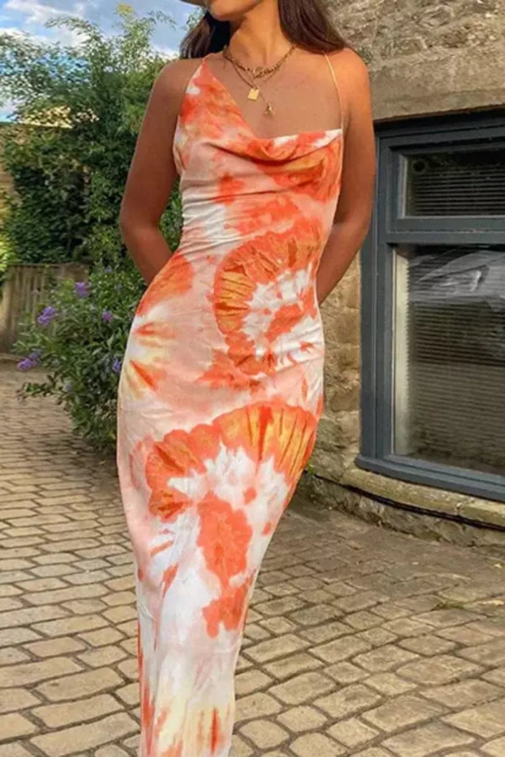 Elegant midi dress featuring a flowing silhouette, perfect for casual outings or summer events. 0