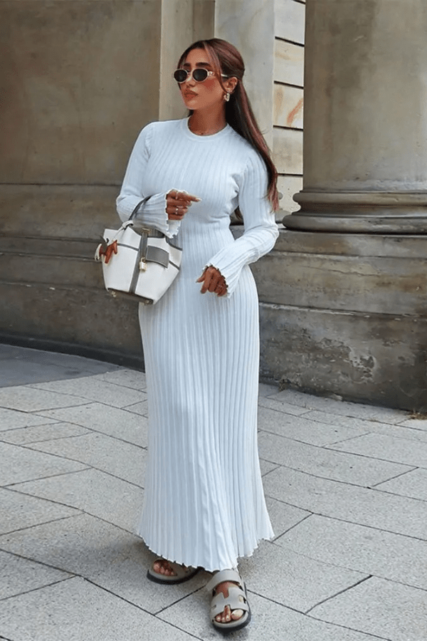 Long sleeve dress with ruffle details and an elegant hem, perfect for formal occasions. 0