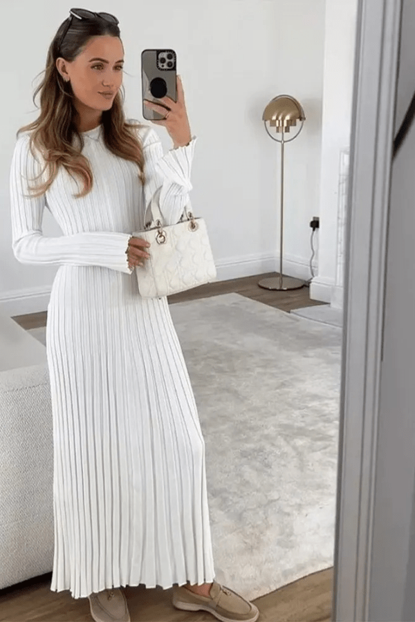 Long sleeve dress with ruffle details and an elegant hem, perfect for formal occasions. 6