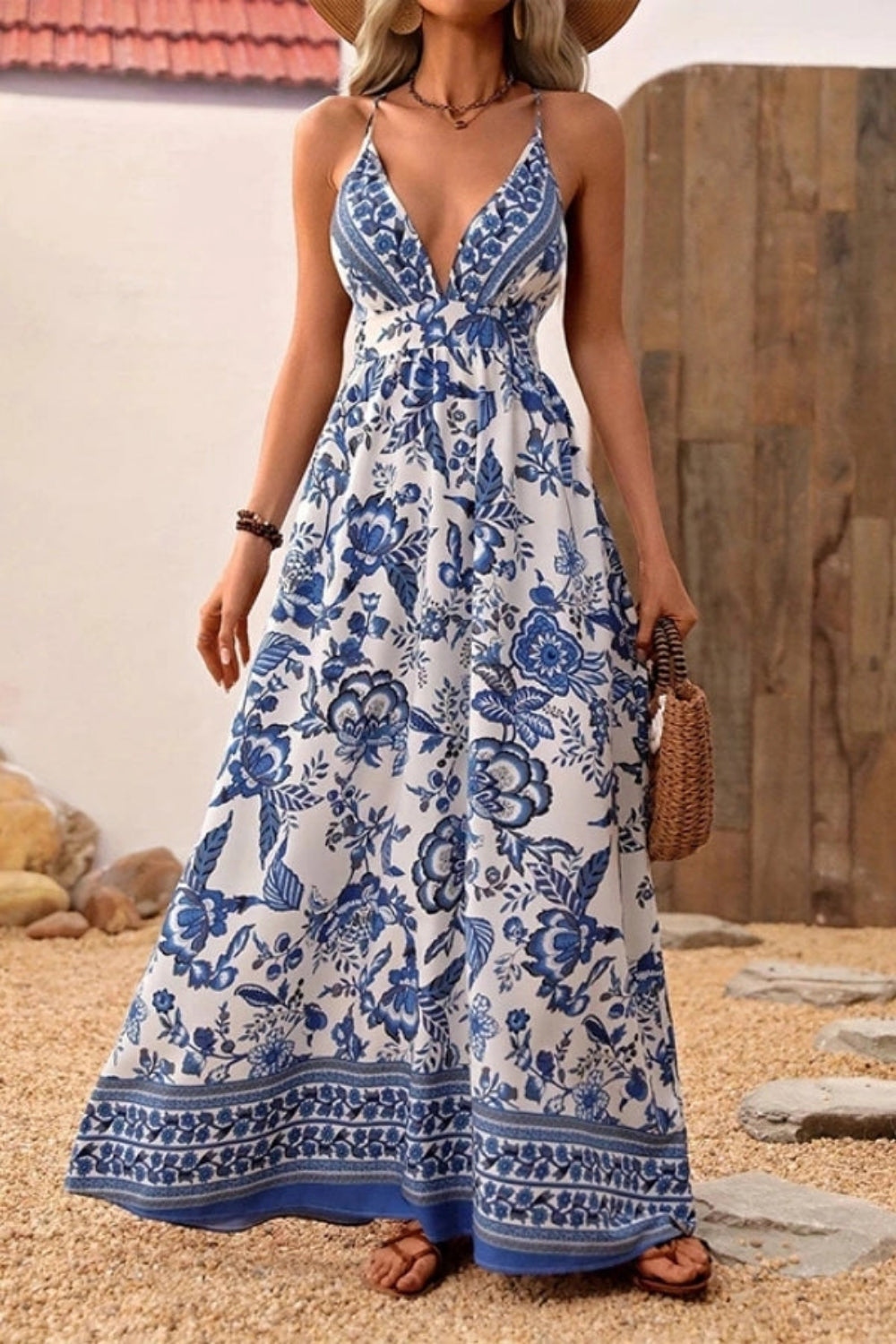 Maxi dress with a deep V-neck and open back, featuring a flowing silhouette suitable for formal occasions. 0