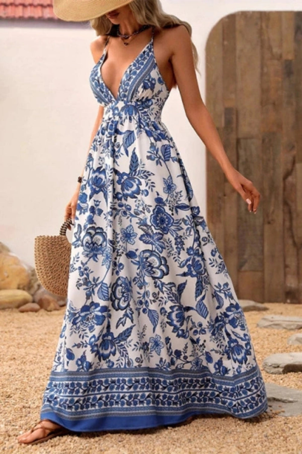 Maxi dress with a deep V-neck and open back, featuring a flowing silhouette suitable for formal occasions. 1