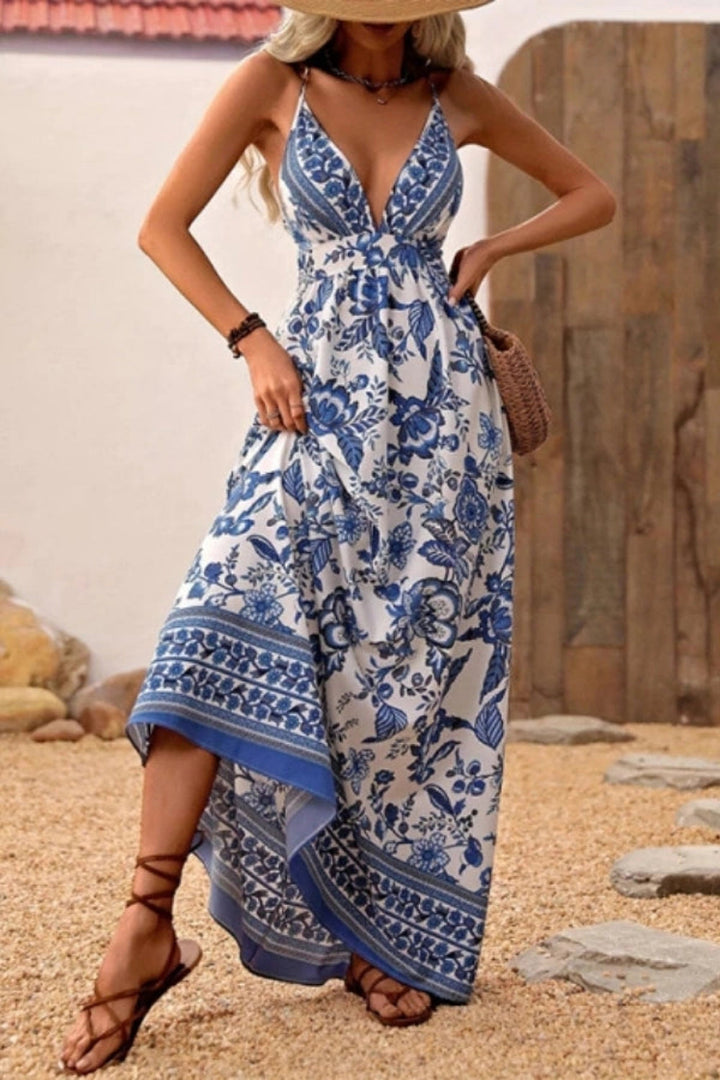 Maxi dress with a deep V-neck and open back, featuring a flowing silhouette suitable for formal occasions. 2