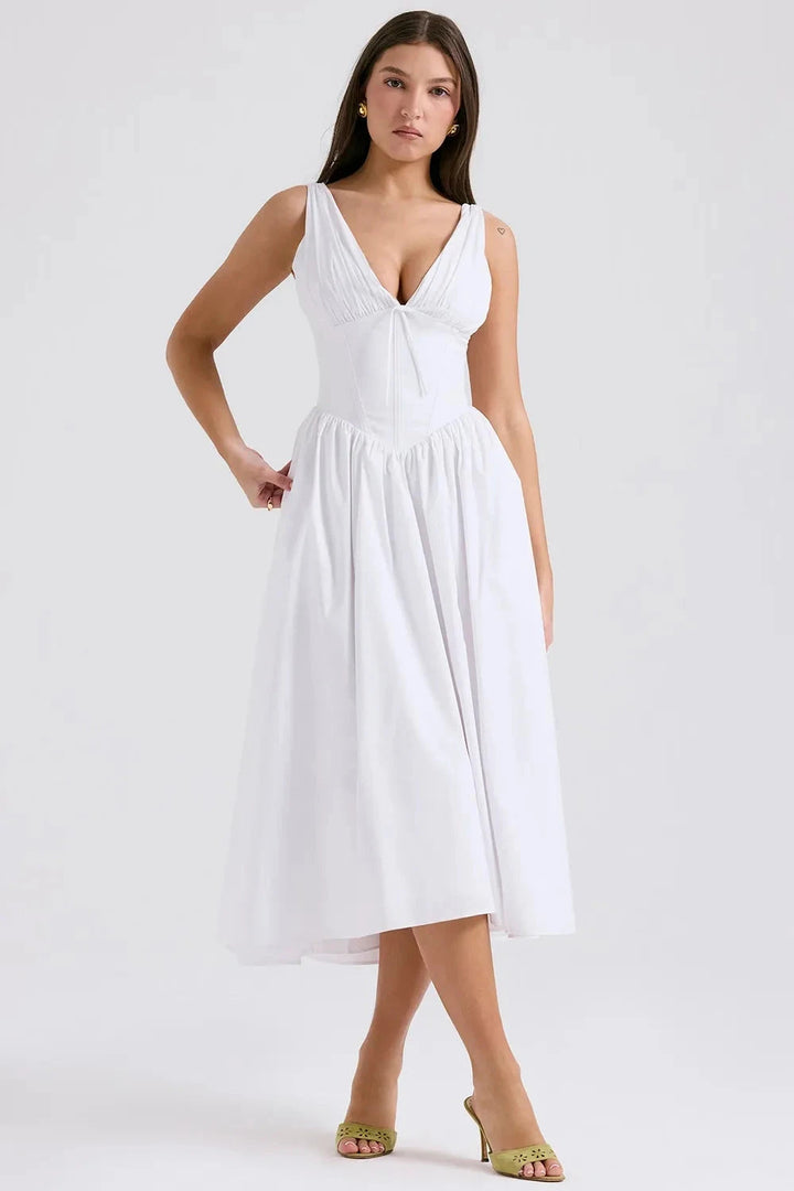 A midi sundress featuring a bold tropical print in a flowing silhouette, perfect for summer outings. 0