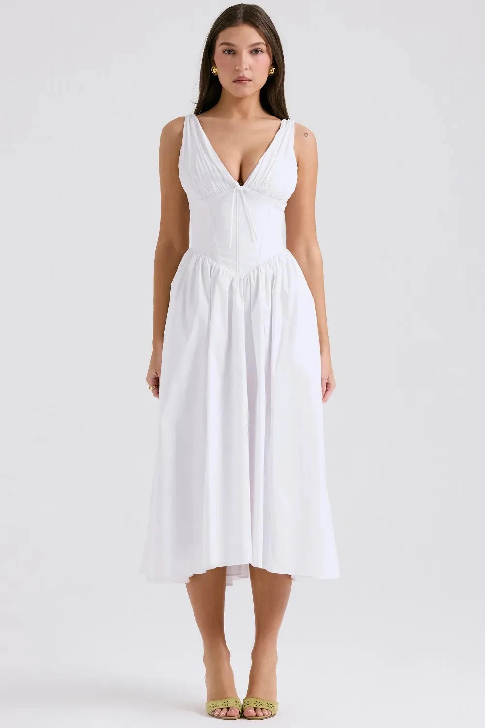 A midi sundress featuring a bold tropical print in a flowing silhouette, perfect for summer outings. 1