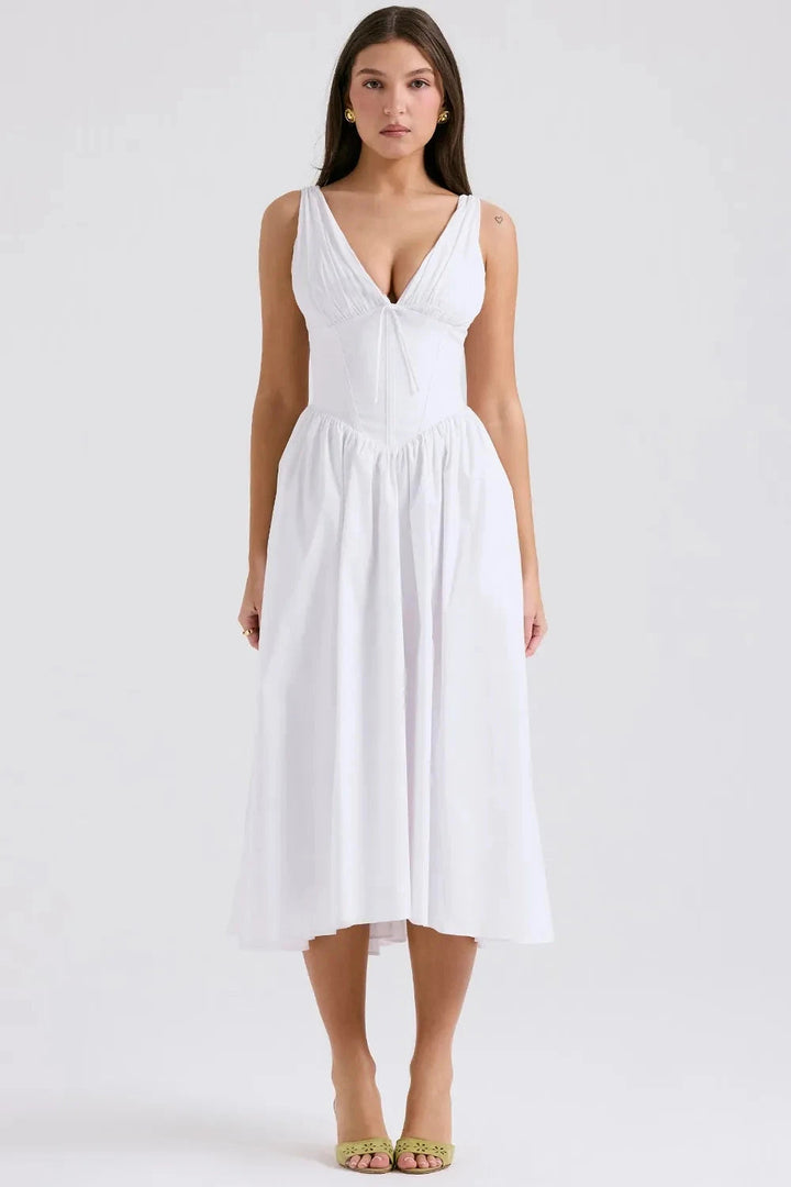 A midi sundress featuring a bold tropical print in a flowing silhouette, perfect for summer outings. 1