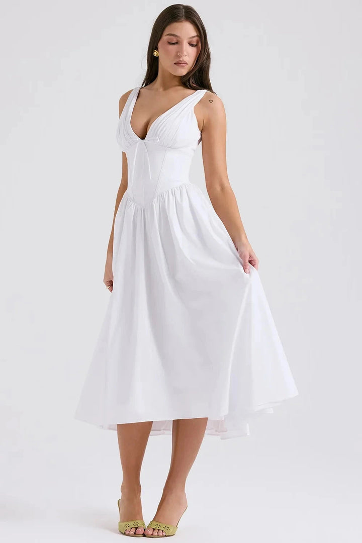 A midi sundress featuring a bold tropical print in a flowing silhouette, perfect for summer outings. 2