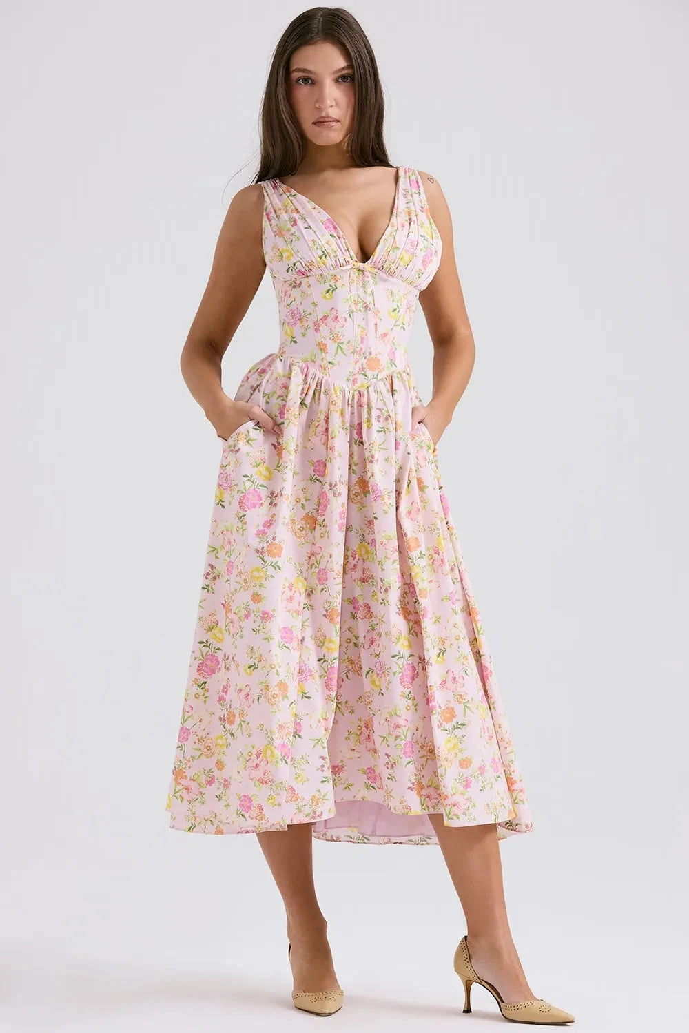 A midi sundress featuring a bold tropical print in a flowing silhouette, perfect for summer outings. 4