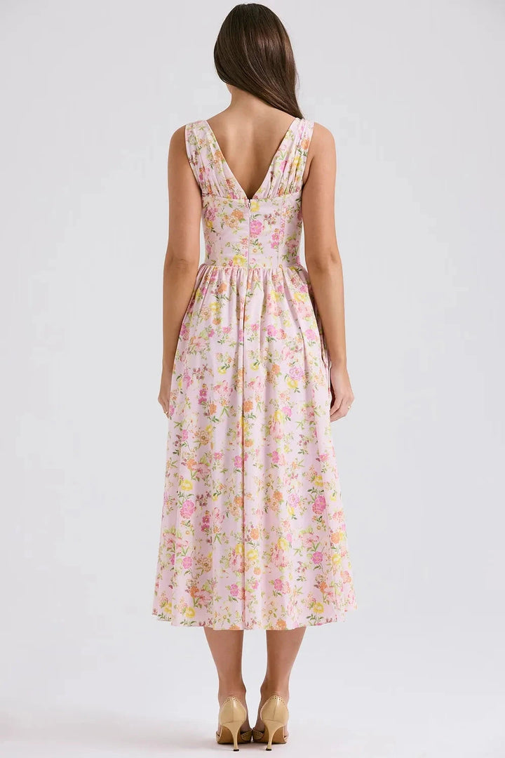 A midi sundress featuring a bold tropical print in a flowing silhouette, perfect for summer outings. 5