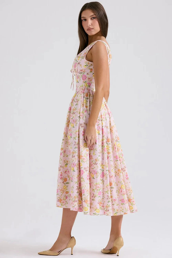 A midi sundress featuring a bold tropical print in a flowing silhouette, perfect for summer outings. 6
