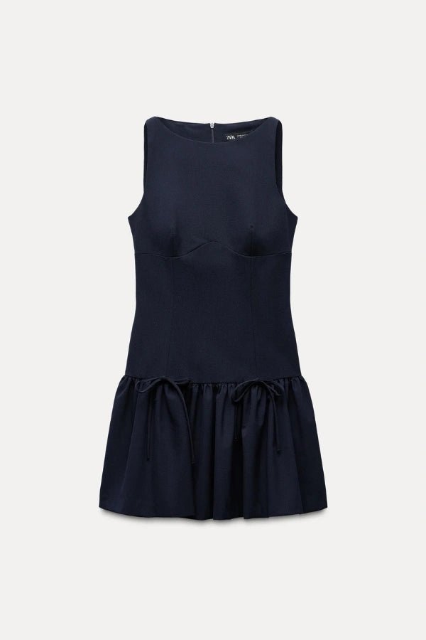 Mini dress with a ruffle design and bow, featuring a fitted silhouette, suitable for casual outings or summer events. 11