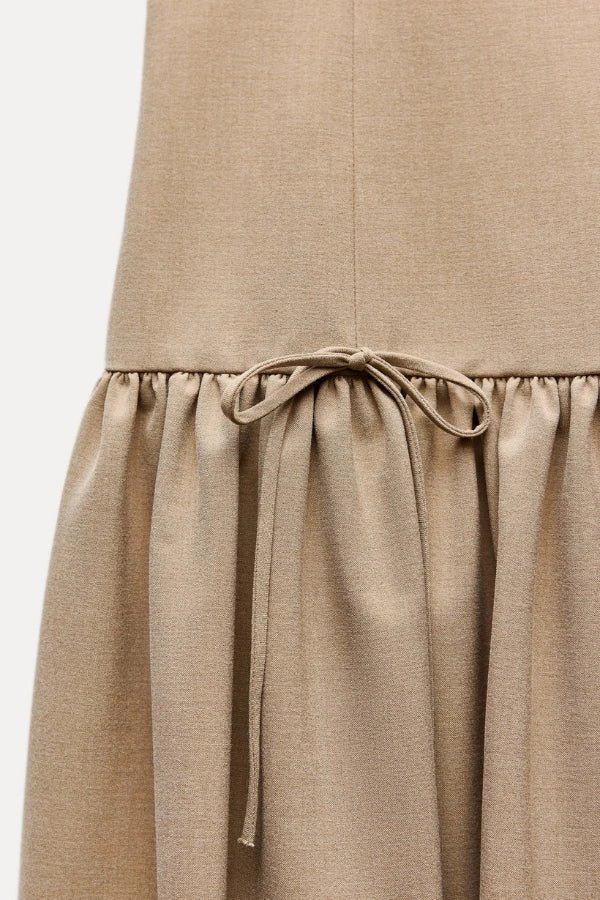 Mini dress with a ruffle design and bow, featuring a fitted silhouette, suitable for casual outings or summer events. 6