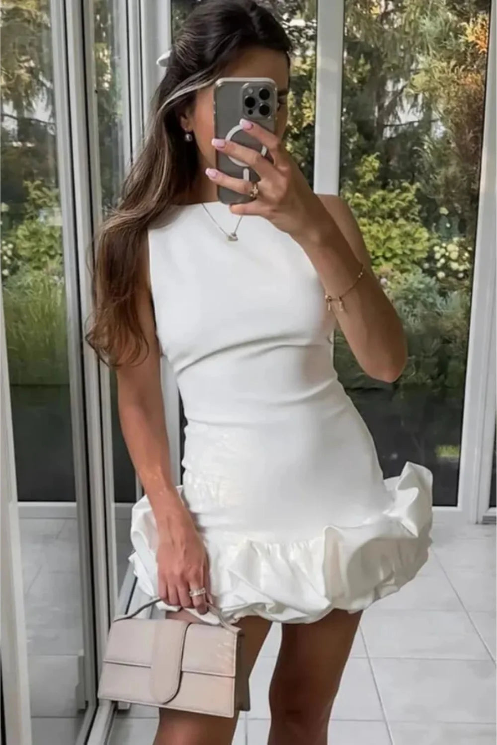 Mini dress with a structured bubble hem, featuring a fitted silhouette, perfect for a casual outing. 1