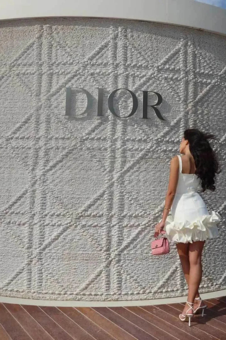 Mini dress with a structured bubble hem, featuring a fitted silhouette, perfect for a casual outing. 2
