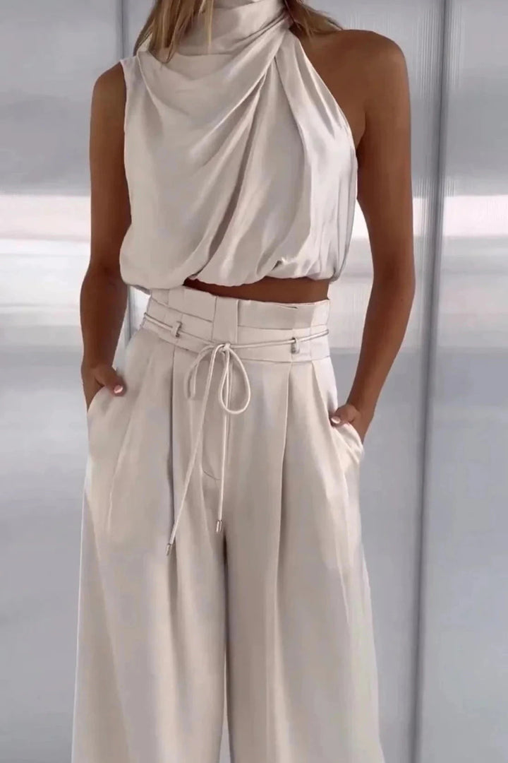 Sleeveless top with a relaxed silhouette paired with wide-leg pants, perfect for summer outings. 1