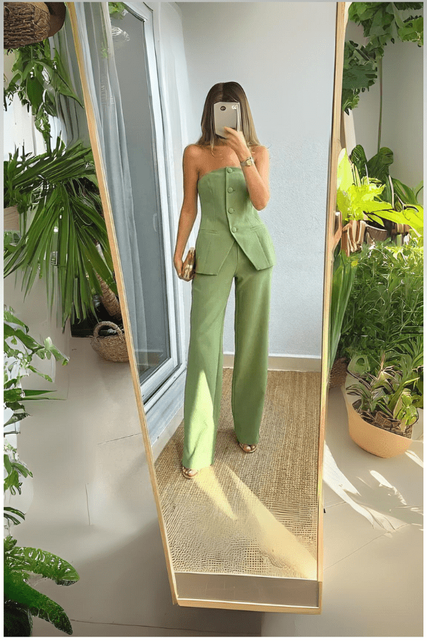 Two-piece outfit featuring a strapless top and tailored bottom, designed for a chic and stylish occasion. 1